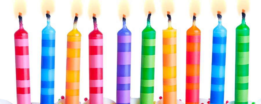 Ten birthday cake candles against a white background